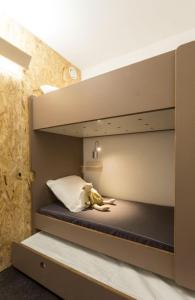 a bunk bed with a dog laying on top of it at Résidence LE VARET - ARC 2000 - Ski-in Ski-out in Bourg-Saint-Maurice