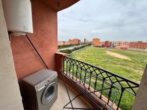 a washing machine on a balcony with a view of a city at Calma in Beni Mellal