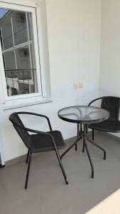 a table and two chairs in a room with a window at OSTRIV Hotel in Zatoka