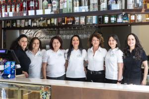 a group of women standing behind a counter at Hotel La Quercia in Valmontone
