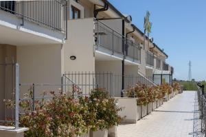 a row of apartment buildings with potted plants at Hotel La Quercia in Valmontone