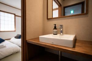 a bathroom with a white sink and a mirror at nozawasnow in Nozawa Onsen +28 photos