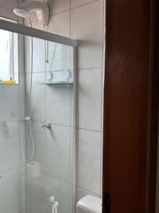 a bathroom with a shower and a toilet at Saif Economy Apart in Paranaguá