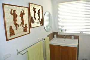 a bathroom with a sink and a mirror at Clambake Beach House in Cape Woolamai +19 photos