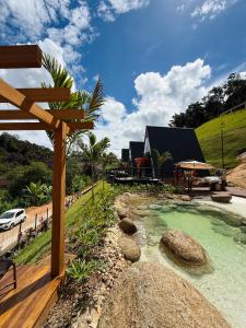 a backyard with a hot tub and a wooden deck at Cabana dos Colibris in Santa Teresa
