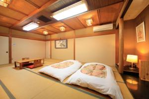 Postel nebo postele na pokoji v ubytování Fujinomiya Green Hotel