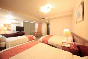 Postel nebo postele na pokoji v ubytování Fujinomiya Green Hotel