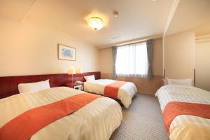 Postel nebo postele na pokoji v ubytování Fujinomiya Green Hotel
