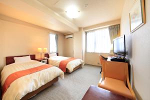 Postel nebo postele na pokoji v ubytování Fujinomiya Green Hotel