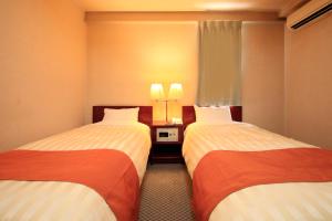 Postel nebo postele na pokoji v ubytování Fujinomiya Green Hotel