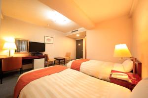 Tempat tidur dalam kamar di Fujinomiya Green Hotel