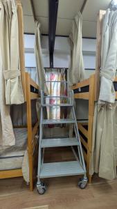 a bunk bed with a cart in a room at 奄美ザナゼステイTheNazeStay in Amami