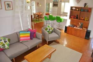 a living room with a couch and a table at Clambake Beach House in Cape Woolamai