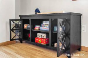 a black cabinet with glass doors in a room at Cabin in Wellston in Wellston
