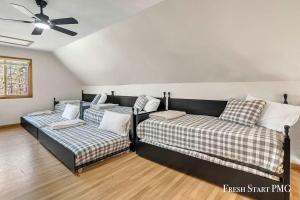 a room with two beds and a ceiling fan at Cabin in Wellston in Wellston +46 photos