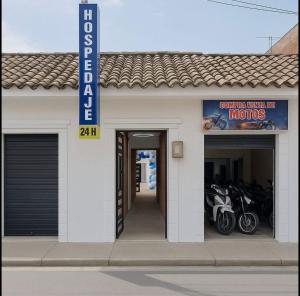 a building with two motorcycles parked outside of it at Hotel Azulado - Como el mar in Jamundí
