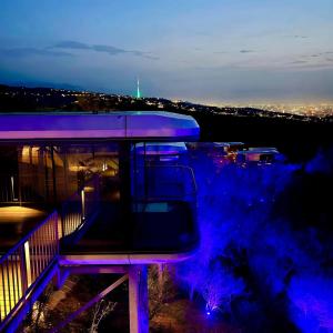 a night view of a building with purple lights at Sunny Home Park in Almaty
