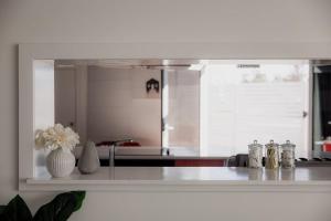 a kitchen with a counter top with a sink and a counter sidx sidx at Ruby SoHo Workshop Villa in Port Sorell +49 photos