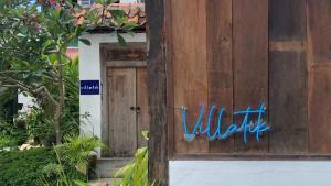 a wooden door with the word wildlife written on it at Villatik in Timuran