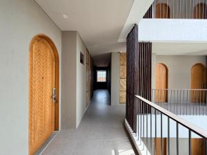 a hallway of a house with wooden doors at Kalpa Tree Co-living in Canggu