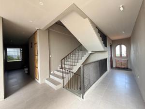 a hallway with a staircase in a house at Kalpa Tree Co-living in Canggu