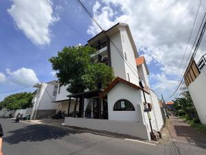 a white building on the side of a street at Kalpa Tree Co-living in Canggu