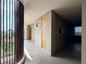 a hallway of a house with a large window at Kalpa Tree Co-living in Canggu +32 photos