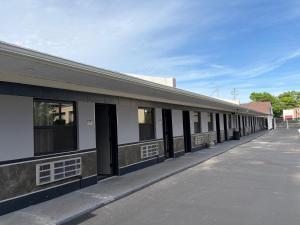 a building with black doors and windows on a street at Midway Motel in Patchogue +15 photos