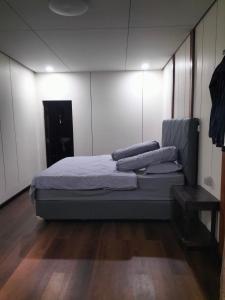 a bedroom with a bed with pillows on it at Pong Elak 'Guest House in Rantepao