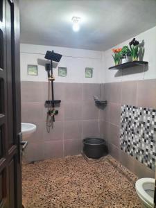 a bathroom with a toilet and a sink at Pong Elak 'Guest House in Rantepao