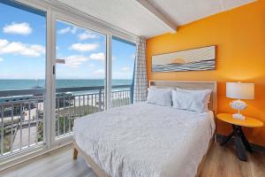 a bedroom with a bed with a view of the ocean at Amazing Large Private Studio Condo with Amazing View in Myrtle Beach