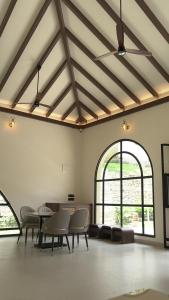 a large room with chairs and tables and windows at La Damai in Aldūr