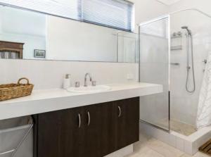 a bathroom with a sink and a shower at Ocean Blue View in Capel