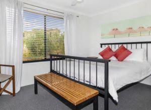 a bedroom with a bed and a bench and a window at Ocean Blue View in Capel