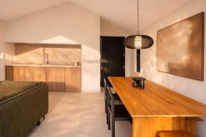 a living room with a wooden table and a couch at Prana Ubud in Tegalalang +147 photos