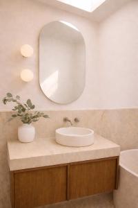 a bathroom with a sink and a mirror at Prana Ubud in Tegalalang