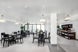 a dining room with tables and chairs and a bar at Aluna Tam Coc Hotel in Ninh Binh +37 photos