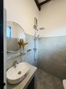 a bathroom with a sink and a mirror at Earthora Escape in Dickwella +25 photos