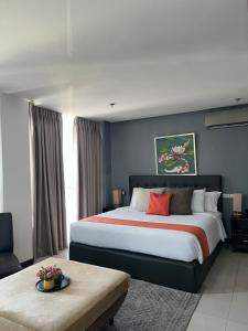a bedroom with a large bed and a table at The Upperhouse Hotel Boutique Stay with City & River Views in Cagayan de Oro