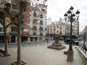a city street with buildings and a street light at Hostal Rual in Cuenca