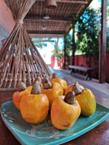 a plate with a pile of pumpkins on a table at Serrambi Praia Suites in Porto De Galinhas
