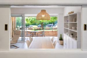 a living room with a table and chairs and a dining room at Hondarribia con Piscinas, Terraza Privada, Parking y Tenis - CASA OLABIDE in Hondarribia