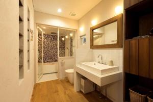 a bathroom with a sink and a toilet and a mirror at お宿 想-Oyado Sou- in Asakura +29 photos
