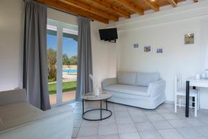 a living room with a couch and a table at Iliana Villas in Lefkada