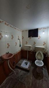 a dirty bathroom with a toilet and a sink at Atithi Stay in Bhubaneshwar