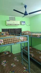 a room with three bunk beds and a fan at Atithi Stay in Bhubaneshwar