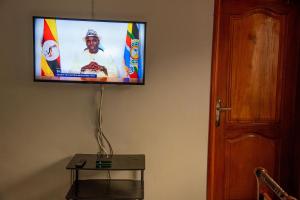 a flat screen tv hanging on a wall at Kasese Explorers Homestay in Kasese
