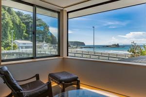 a room with a window with a view of the ocean at みささ in Kyonan +15 photos