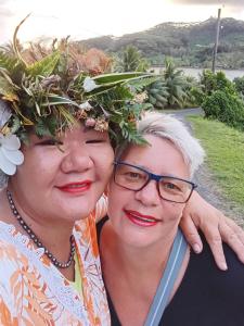 two women wearing areath of flowers on their heads at TEMATAOAVEA Dortoir in Fare