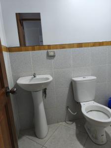 a bathroom with a toilet and a sink at Hostal jm in Huancayo